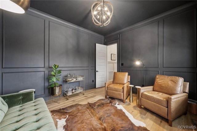 interior space featuring light wood finished floors, an inviting chandelier, and a decorative wall