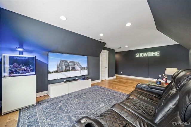 home theater room with visible vents, recessed lighting, light wood-style flooring, and baseboards