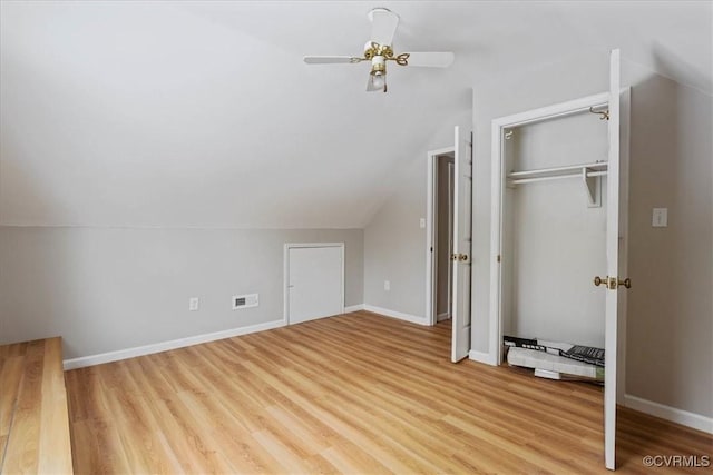 additional living space with lofted ceiling, light hardwood / wood-style flooring, and ceiling fan