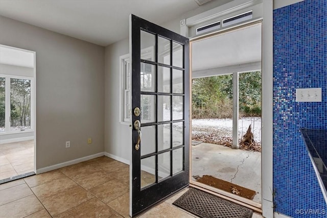 doorway to outside featuring tile patterned flooring