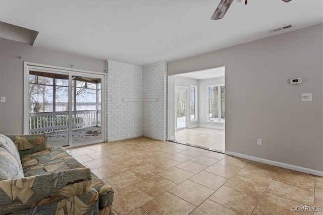 living room with ceiling fan and light tile patterned flooring