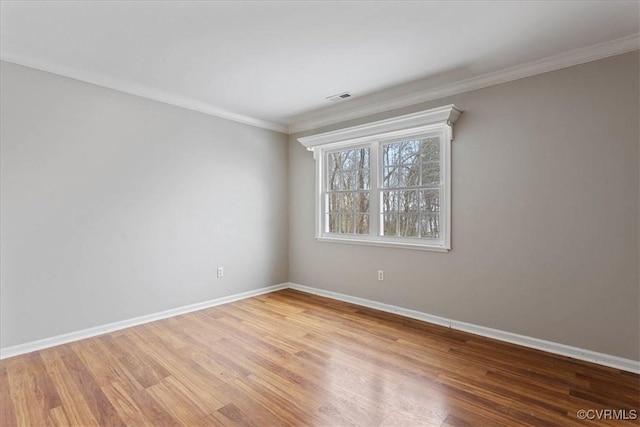 unfurnished room with hardwood / wood-style floors and crown molding