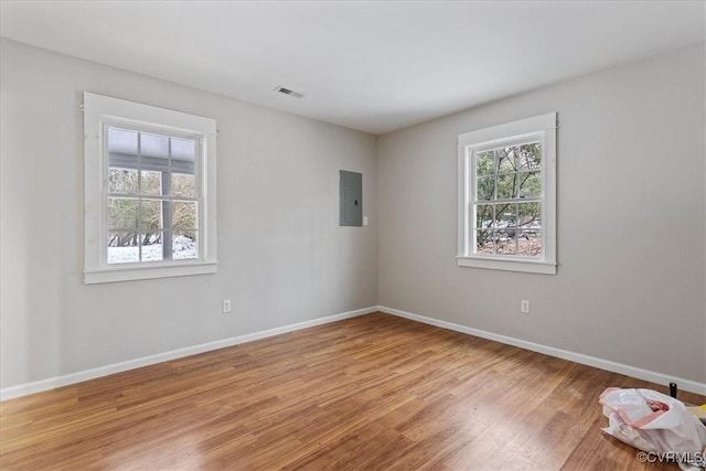 spare room with hardwood / wood-style flooring and electric panel