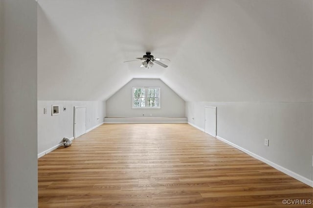 additional living space with wood-type flooring, vaulted ceiling, and ceiling fan