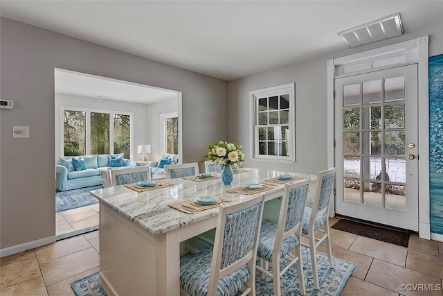 dining space featuring light tile patterned floors