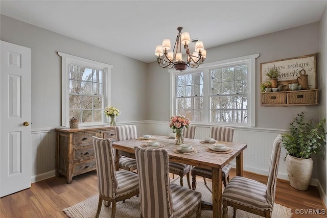 dining room with a chandelier and light hardwood / wood-style floors