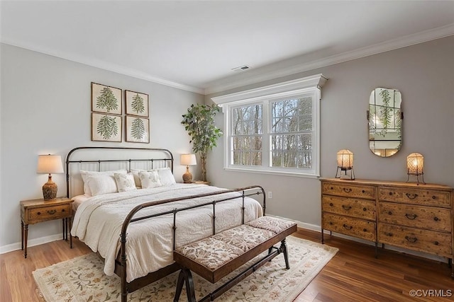 bedroom featuring crown molding and hardwood / wood-style flooring