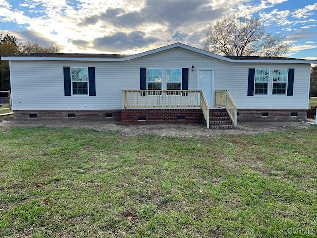 back of house featuring a yard and a deck