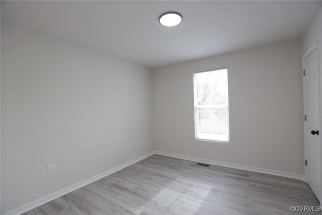 spare room featuring light wood-type flooring