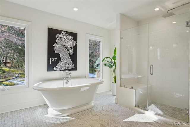 bathroom with independent shower and bath and tile patterned flooring