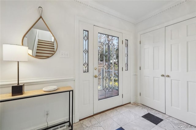 entrance foyer featuring a baseboard heating unit and crown molding