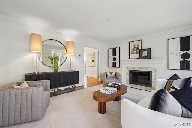 living room with crown molding, a fireplace, and hardwood / wood-style floors