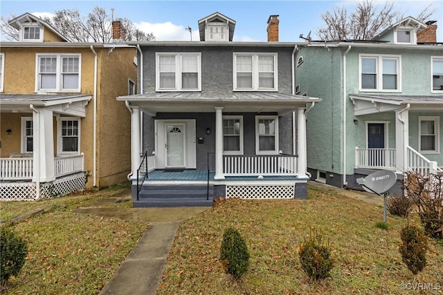 townhome / multi-family property featuring a front yard and covered porch