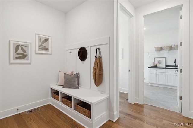 mudroom with wood-type flooring