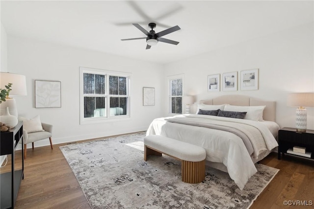 bedroom with ceiling fan and dark wood-type flooring