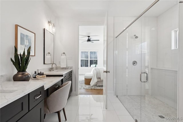 bathroom featuring ceiling fan, walk in shower, vanity, and a healthy amount of sunlight