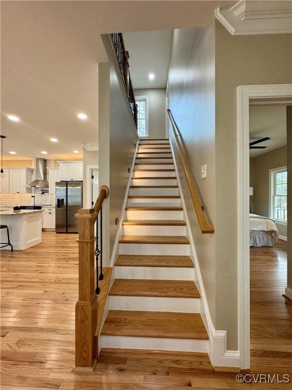 stairs with recessed lighting, baseboards, and wood finished floors