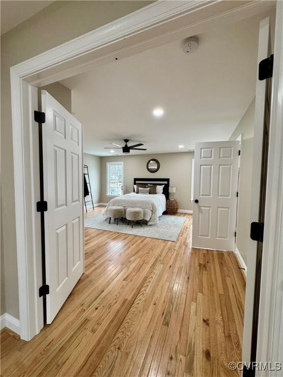 unfurnished bedroom with light wood finished floors and baseboards