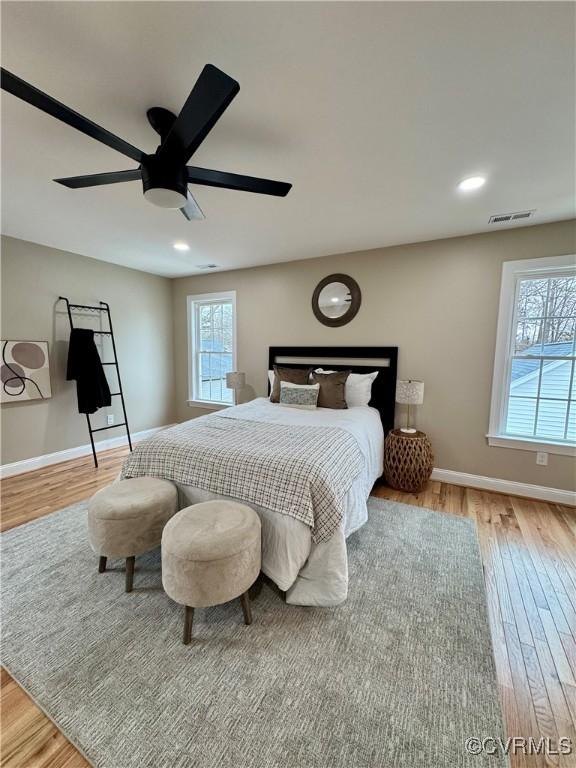 bedroom with visible vents, baseboards, a ceiling fan, light wood-style flooring, and recessed lighting