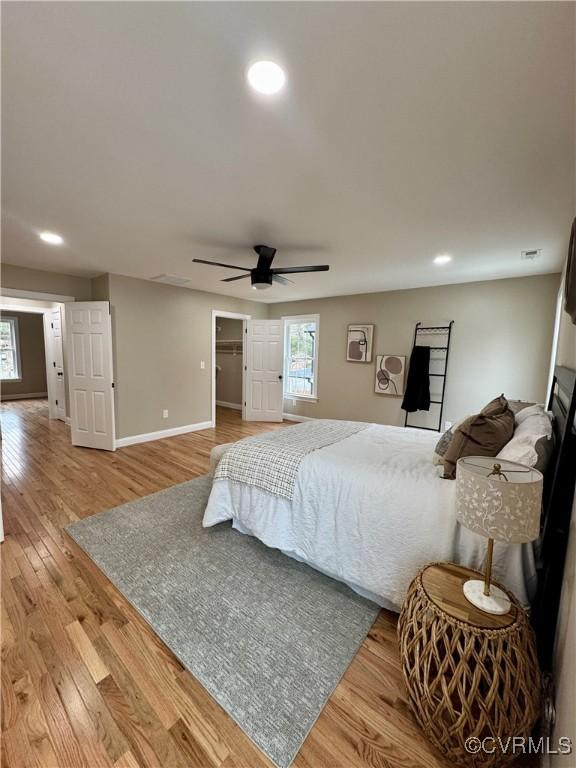 bedroom with a ceiling fan, baseboards, wood finished floors, and recessed lighting