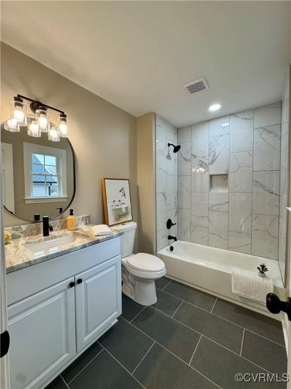 full bathroom with visible vents, toilet, shower / bathtub combination, tile patterned floors, and vanity