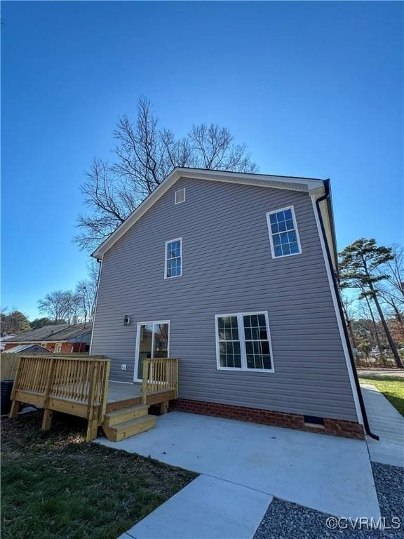 back of property featuring a wooden deck