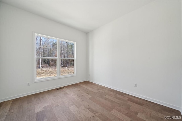 unfurnished room with light hardwood / wood-style flooring