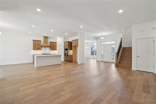 unfurnished living room featuring light hardwood / wood-style flooring