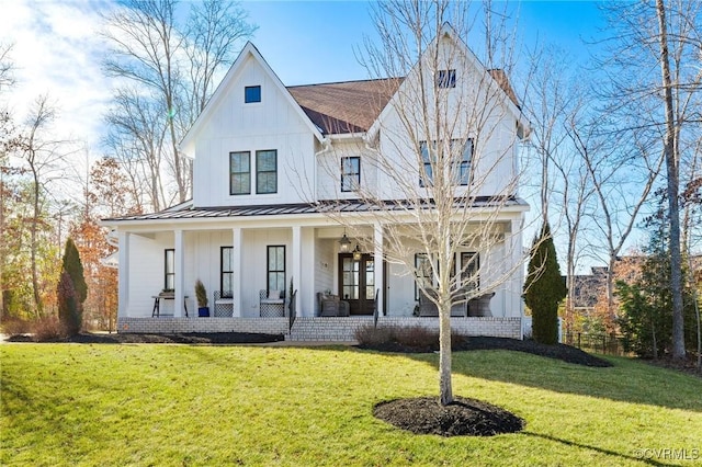 modern farmhouse style home featuring covered porch and a front lawn