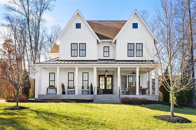 modern farmhouse style home featuring brick siding, board and batten siding, a front lawn, a porch, and a standing seam roof