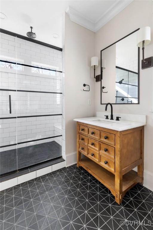 bathroom with vanity, crown molding, and walk in shower