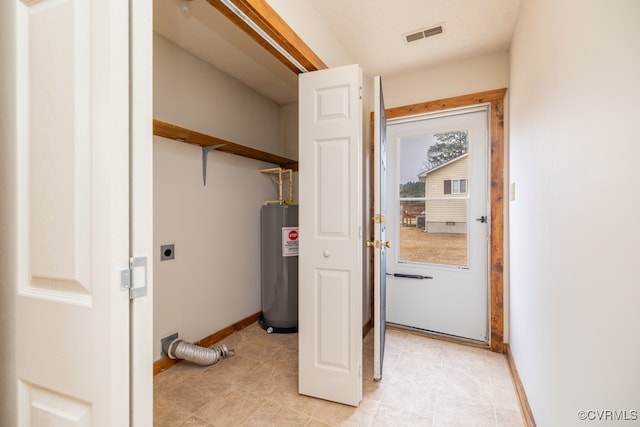 clothes washing area with water heater and hookup for an electric dryer