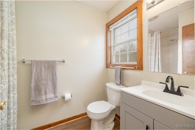 bathroom with toilet, vanity, and a shower with shower curtain