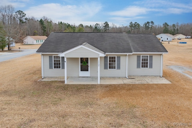 ranch-style house with a patio area and a front lawn