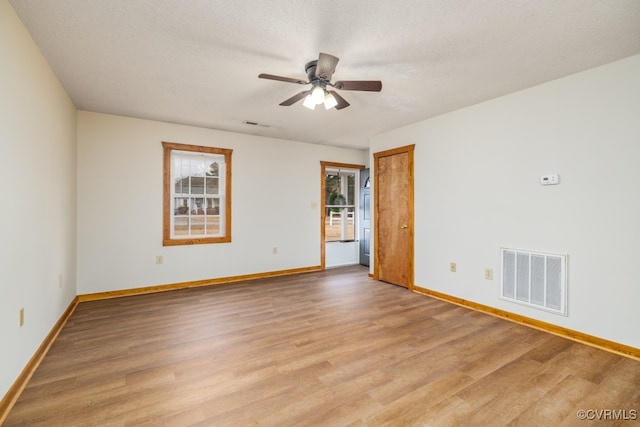 unfurnished room with light wood-type flooring, a textured ceiling, and ceiling fan