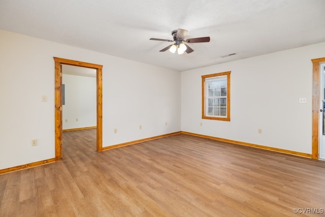 empty room with ceiling fan and light hardwood / wood-style floors