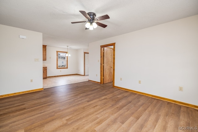 spare room with hardwood / wood-style floors, a textured ceiling, and ceiling fan