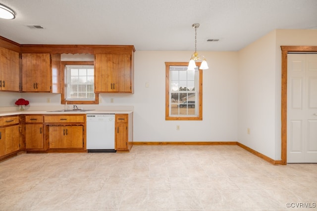 kitchen with sink, an inviting chandelier, pendant lighting, and white dishwasher