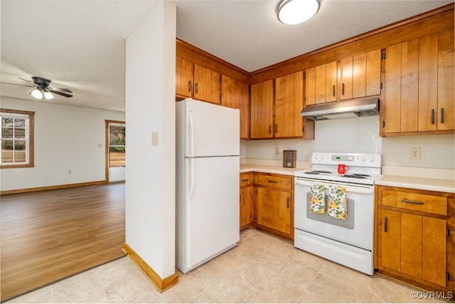 kitchen with ceiling fan, white appliances, and a textured ceiling