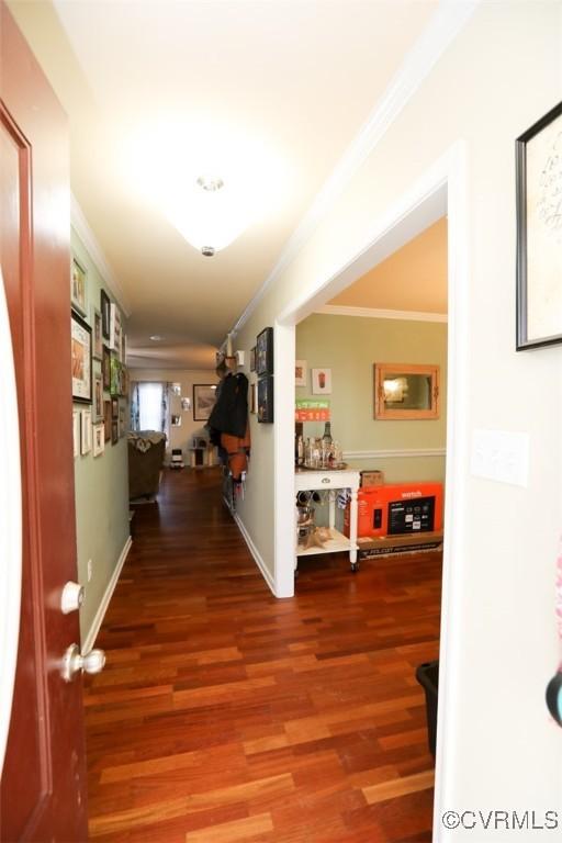 hall featuring ornamental molding and wood-type flooring