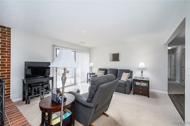 carpeted living room with a textured ceiling