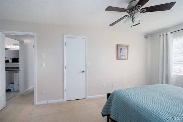 carpeted bedroom featuring ceiling fan and a textured ceiling