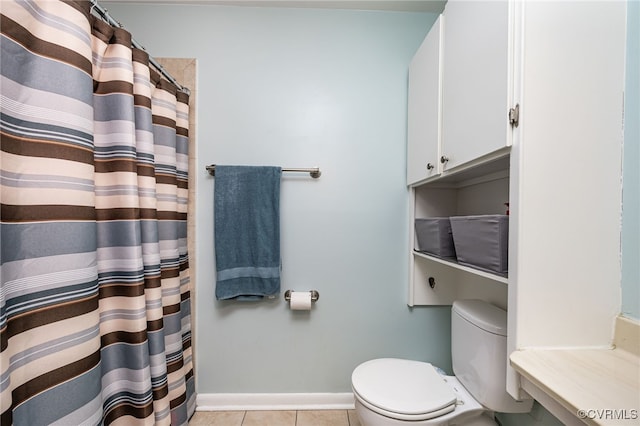 bathroom with toilet and tile patterned flooring