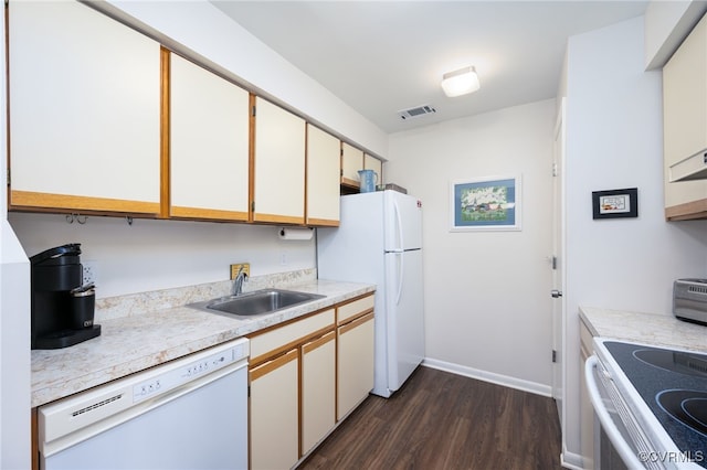 kitchen with white cabinetry, sink, white appliances, and dark wood-type flooring