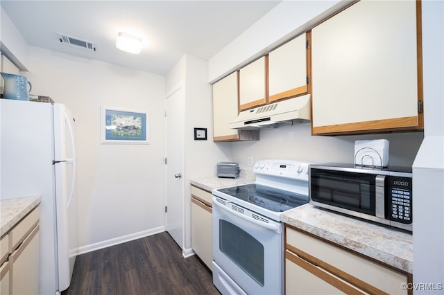 kitchen featuring white appliances, white cabinetry, and dark wood-type flooring