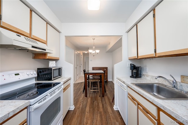 kitchen with white appliances, white cabinetry, sink, decorative light fixtures, and dark hardwood / wood-style flooring