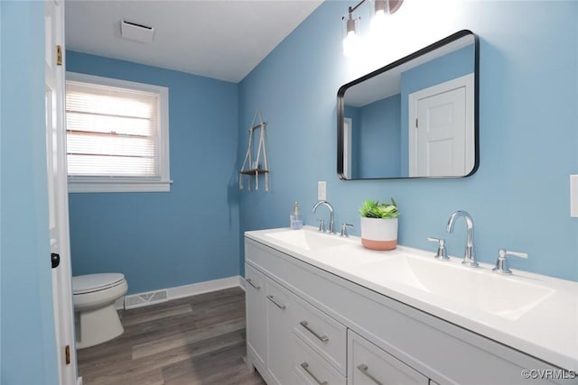 bathroom featuring hardwood / wood-style flooring, vanity, and toilet