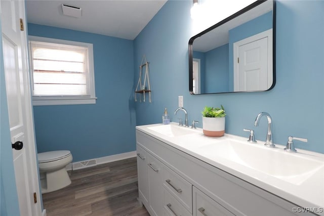 bathroom with vanity, hardwood / wood-style floors, and toilet