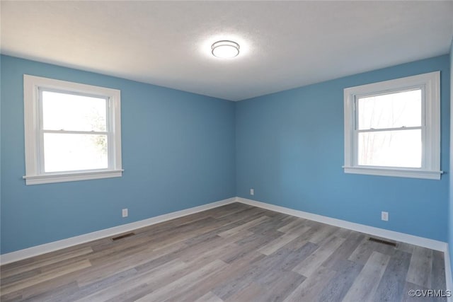 spare room with light wood-type flooring