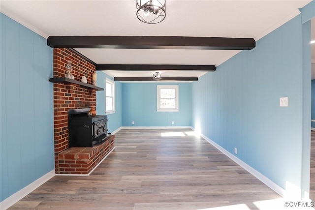 unfurnished living room featuring hardwood / wood-style flooring, a wood stove, and beam ceiling